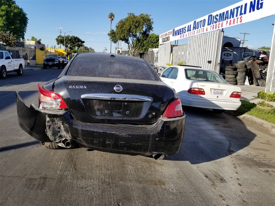 Damaged Nissan Maxima outside Universal Auto Dismantling